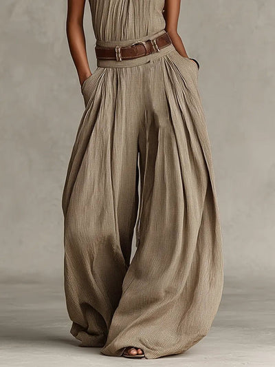 Greta | Mouwloze dames halterneck-jumpsuit met wijde pijp en ceintuur