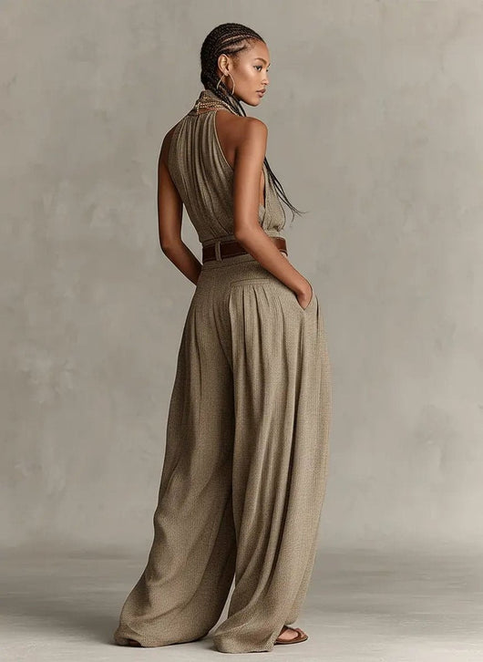 Greta | Mouwloze dames halterneck-jumpsuit met wijde pijp en ceintuur