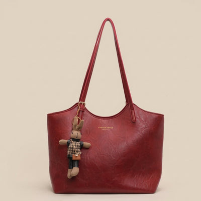 Mia | Dames schoudertas van veganleer met pluche hanger