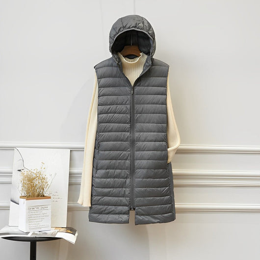 Clara | Lange mouwloze gewatteerde dames bodywarmer met capuchon